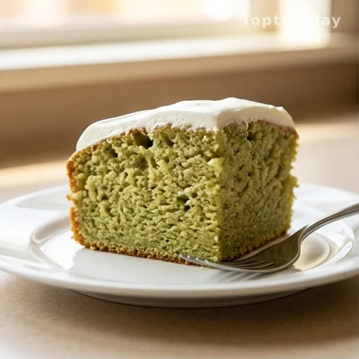 Slice of moist pistachio pineapple cake on a white plate showing interior crumb