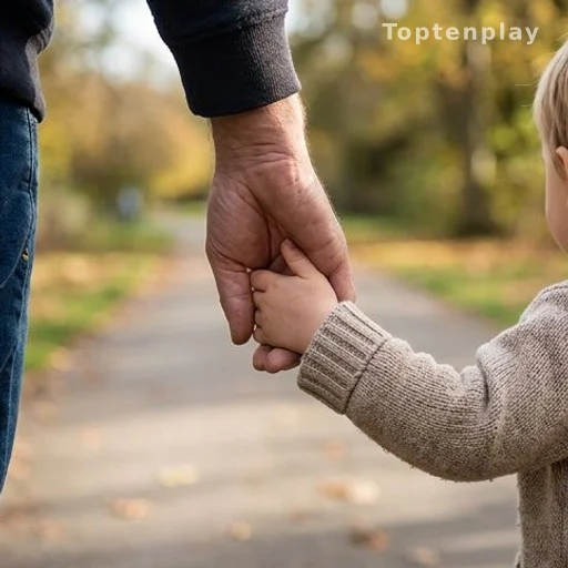 Parent holding child's hand on a park path, autism child safety awareness