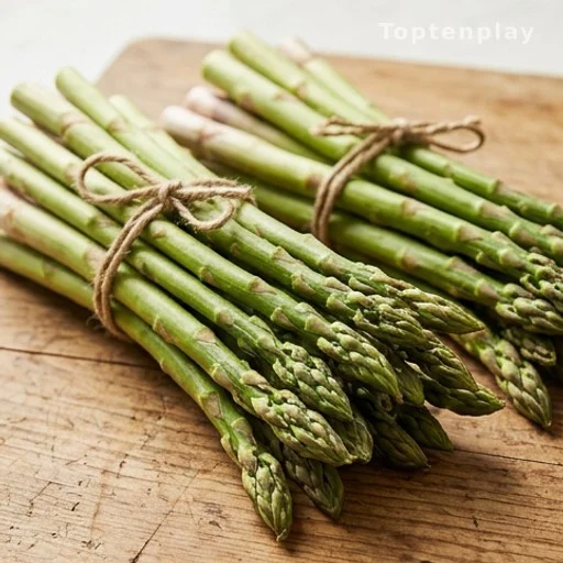 Fresh asparagus spears rich in Vitamin K and antioxidants on wooden surface