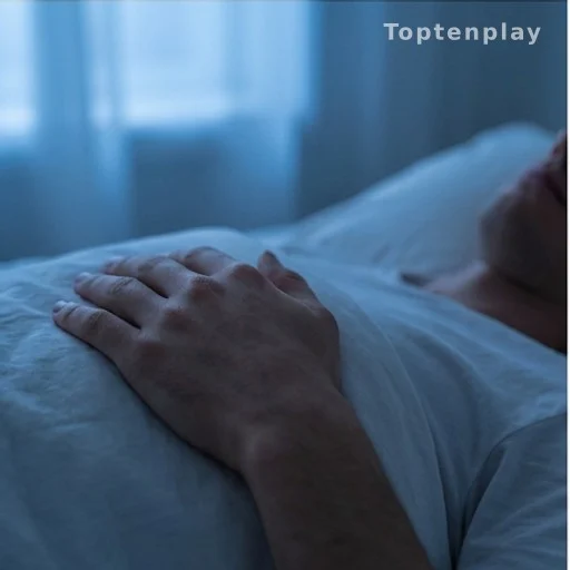 Person resting hand on chest in bed, illustrating heart health and sleep position