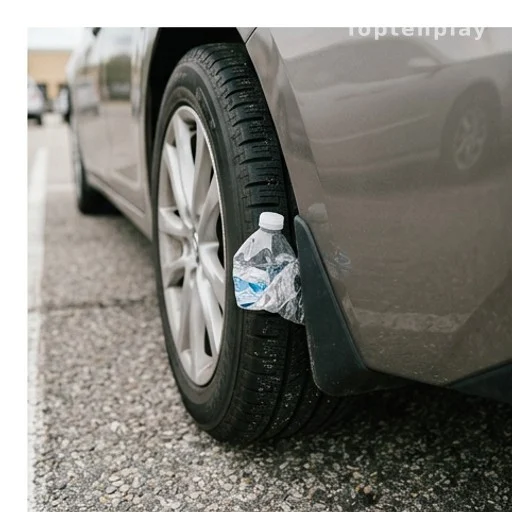 plastic bottle wedged between car tire and wheel well, vehicle theft tactic