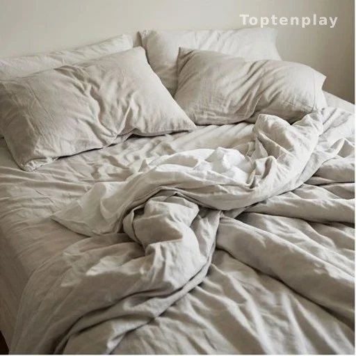 Empty bed with pillows in different positions illustrating various sleeping styles