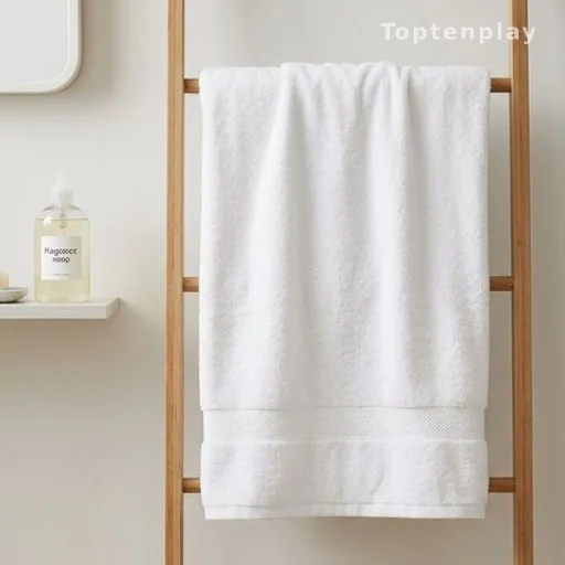 White bath towel hanging to dry in a ventilated bathroom with fragrance-free soap
